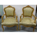Matching Pair of Carved Limewood Salon Armchairs, the padded seat covered with musical patterns,