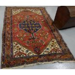 Wool Floor Rug, red ground with navy and cream patterns around a central medallion, 1.3m x 2.0m