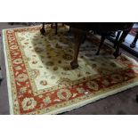 Zeigler Floor Rug, beige ground with red patterned borders (as new) 2m x 2.57