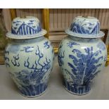 Matching Pair of tall bulbous Vases, with lids, blue and white, decorated with Chinese landscapes (