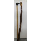 2 wooden walking sticks – 1 mounted with a carved ducks head & 1 with figure of a “spook”, on a