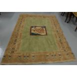 Wool Floor Rug, salmon colour ground with central tree pattern and abstract borders, 1.37m x 1.94m