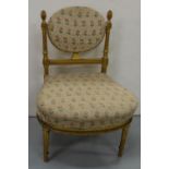Low Sized French carved gilt Salon chair, with pineapple shaped finials and beige floral fabric