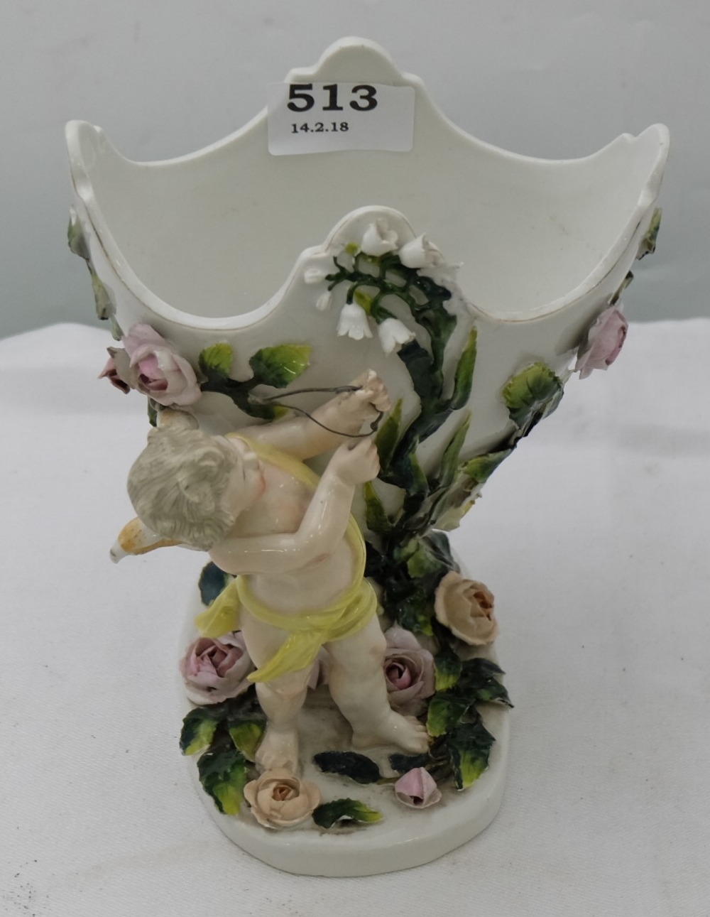 Dresden pot pourri bowl, supported by a cupid figure, raised floral detail, 7”h