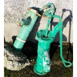2 hand operated half sized water pumps, painted green