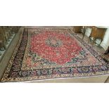 Large red ground Persian Mashad Carpet with a traditional floral medallion design, red ground 2.9