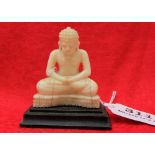 Ivory figure of a seated buddah, on a wooden base, 3”h