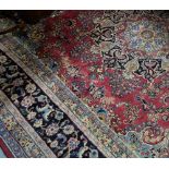 Persian Wool Floor Rug, red central ground with multiple navy ground borders, 2.8m x 3.6m