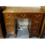 Kneehole mahogany writing desk of compact proportions, with 4 drawers on either side and a central