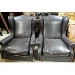 Matching Pair of Brown Leather Wingback Armchairs, on cream painted sabre legs