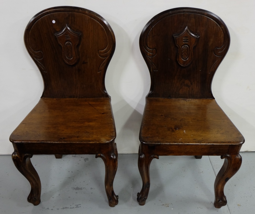 Matching pair pitch pine, mahogany finish hall chairs with cabriole front legs and crested backs (