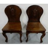 Matching pair pitch pine, mahogany finish hall chairs with cabriole front legs and crested backs (