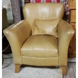 Modern tan leather armchair with cushion