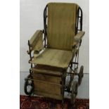 Adjustable antique hospital wheelchair with canvas back and seat