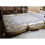 Matching pair of Ercol single beds, boat shaped, on castors, with mattresses (as new) (2)