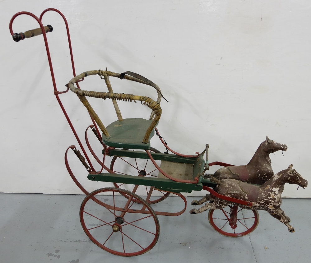 Child's iron based cart on 3 wheels with galloping horses pulling it, painted red/green, 48"w x 42"h