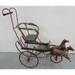 Child's iron based cart on 3 wheels with galloping horses pulling it, painted red/green, 48"w x 42"h