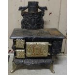 Miniature metal stove with hot plate and chimney, 17"w x 26"h