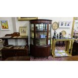 Bowfront mahogany display cabinet, the central glazed door and side glass panels over a single