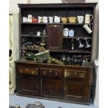 Early 19th Century oak dresser with a dental moulded top, open back with 3 shelves over a base with