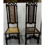Matching pair of carved oak highback hall chairs, bergere seats and backs (one seat damaged)