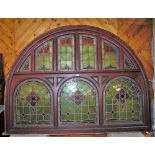 Antique pitch pine domed top over door with 6 shaped stained glass upper panels over 3 similarly