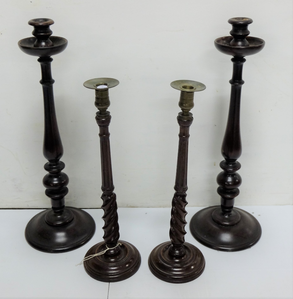 2 pairs of tall turned mahogany candlesticks, one with brass tops, late 19th C, one 21"h, one 17"