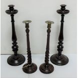 2 pairs of tall turned mahogany candlesticks, one with brass tops, late 19th C, one 21"h, one 17"
