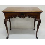 Irish 19th C Georgian style mahogany side table with decorative carved frieze centered on a stylized