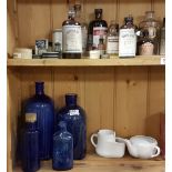 Group of four chemists cobalt blue bottles and a Box of antique chemist items including Victorian