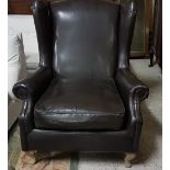 Matching Pair of Brown Leather Wingback Armchairs, on cream painted sabre legs