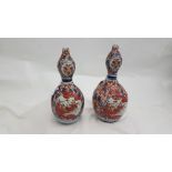 Matching pair of Imari bulbous bud vases, glazed blue/red floral patterns, 8"h x 3"dia