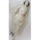 Porcelain Doll 15” tall, with fabric body wearing a cream dress and pink ribbon, black hair