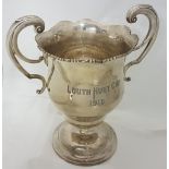 Large Irish Silver Trophy Cup “The Louth Hunt Cup 1910” with double scrolled handles, on a shaped