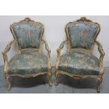Matching Pair of carved Gilt Wood Framed Salon Armchairs, with foliage design pediments, over blue