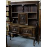 Early 20th Century oak dresser with a moulded top over 5 open shelves, a bowfront base and 2 cabinet