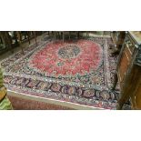Large red ground Persian Mashad Carpet with a traditional floral medallion design 3.85m x 2.25m