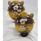 Pair of Japanese pottery moon shaped vases, yellow ground with white floral pattern, dragon handles,