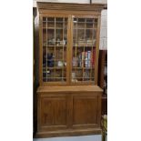 Stripped antique pine 2 door bookcase with glazed and panelled upper doors over 2 doors enclosing