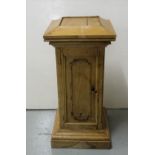 Antique stripped pitch pine pedestal with moulded panels and door enclosing shelves, 35"h x 17"