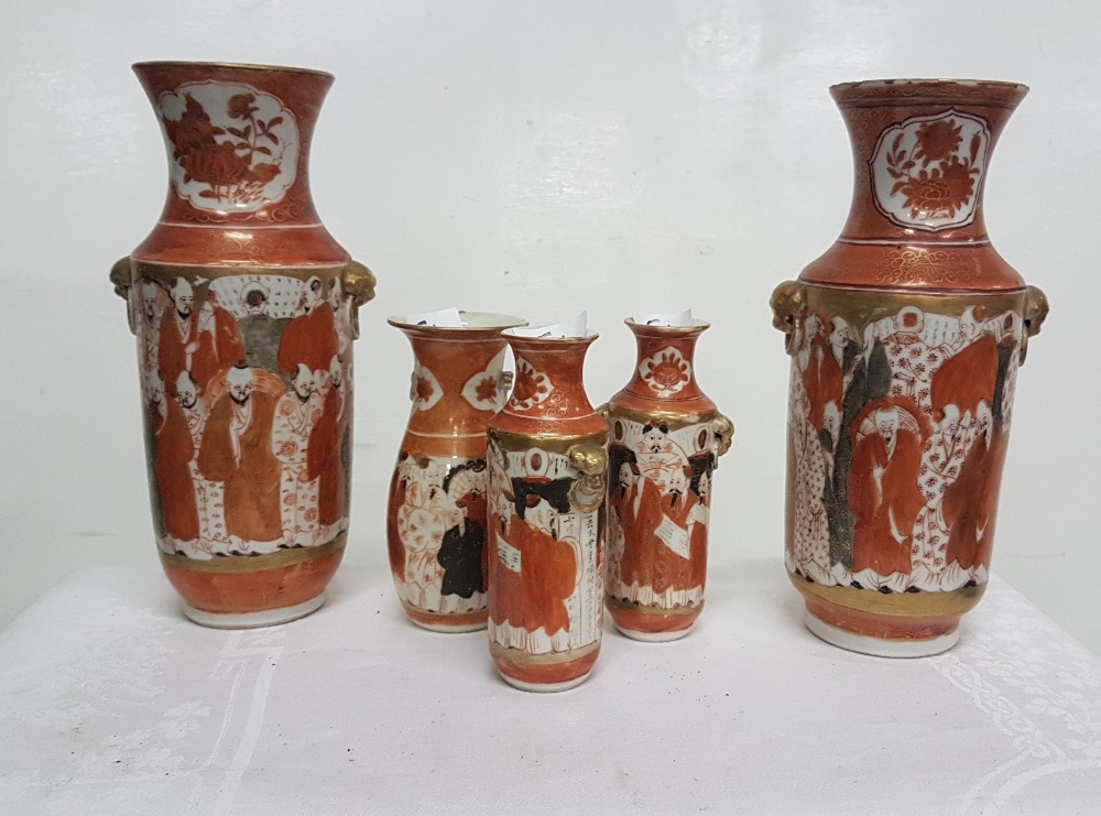 Matching pair of Japanese vases, red ground, decorated with continuous pattern of figures at