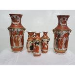 Matching pair of Japanese vases, red ground, decorated with continuous pattern of figures at