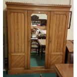 19thC Pitch Pine 3-Door Wardrobe, the gothic style pediment over two doors (1 with mirror panel)