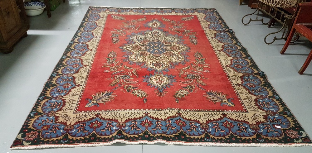 Red ground Persian Tabriz Carpet, with a unique floral medallion design, 2.40 x 3.80