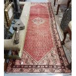 Washed red ground Iranian runner with a traditional Sarouch Mea design, 2.95m x 0.9m