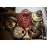 Pair of brass lamp bases and other lamp parts including a table lamp with red glass bowl