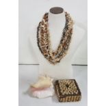 5 African necklaces made of various coloured seashells, a shell trinket box and large conch shell (