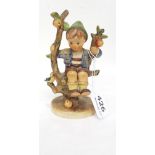Goebel (Western Germany) figurine of a boy seated on a tree stump, stamped T42, 6"h