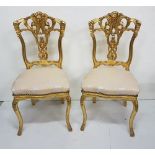 Matching Pair of Ornate Gilt Salon Chairs, decorative splat backs, over beige upholstered seats,