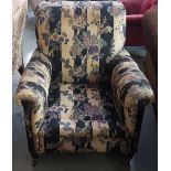 Late 19thC Armchair, on tapered mahogany legs and castors, blue floral fabric